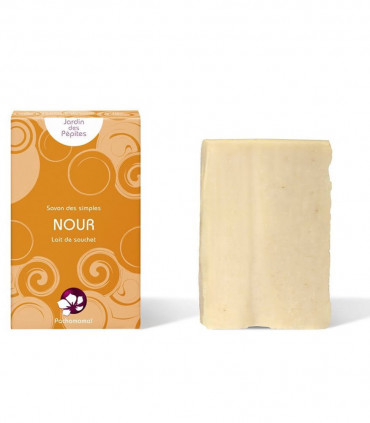 Pachamamai Nour cream colored exfoliating bar soap with cardboard package on the side